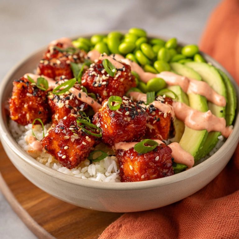 Sweet & Spicy Tofu Power Bowl with a close-up view of the saucy tofu cubes and fresh garnishes.