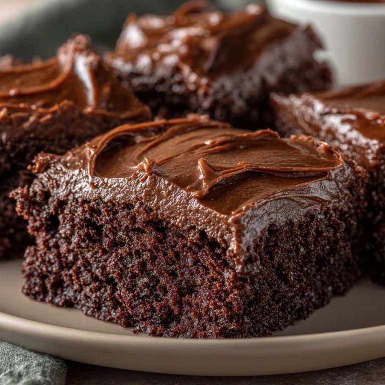 Decadent chocolate fudge cake close-up slice showing moist interior texture and rich frosting.