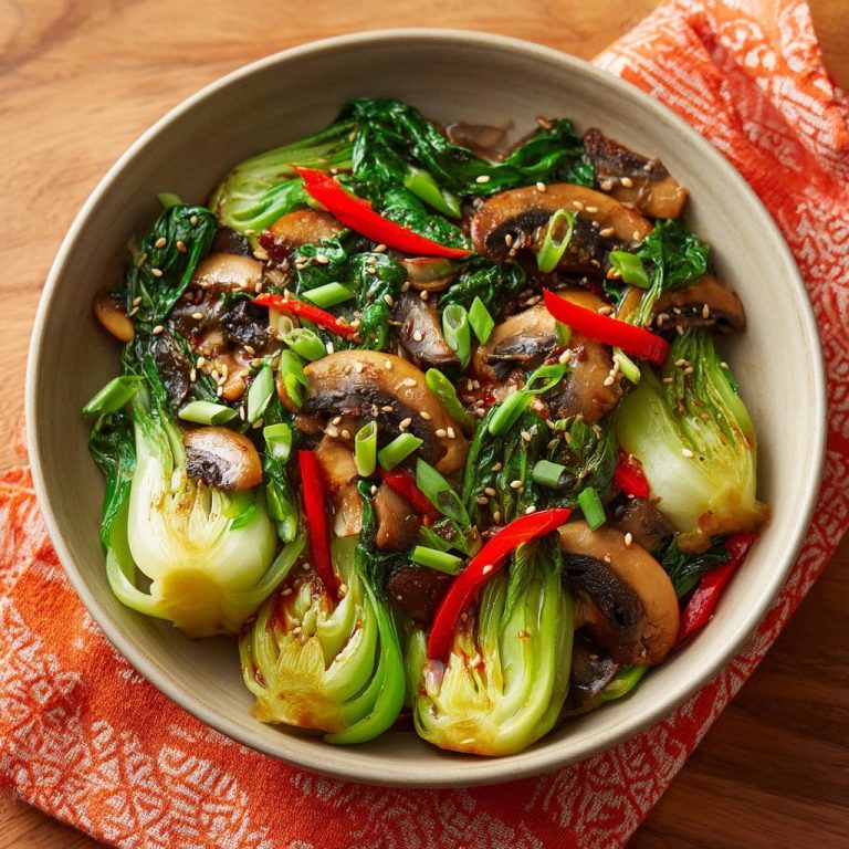 Savory Garlic Mushroom Bok Choy Stir-Fry served in a bowl, showcasing a vibrant overhead view with chili and sesame seeds.