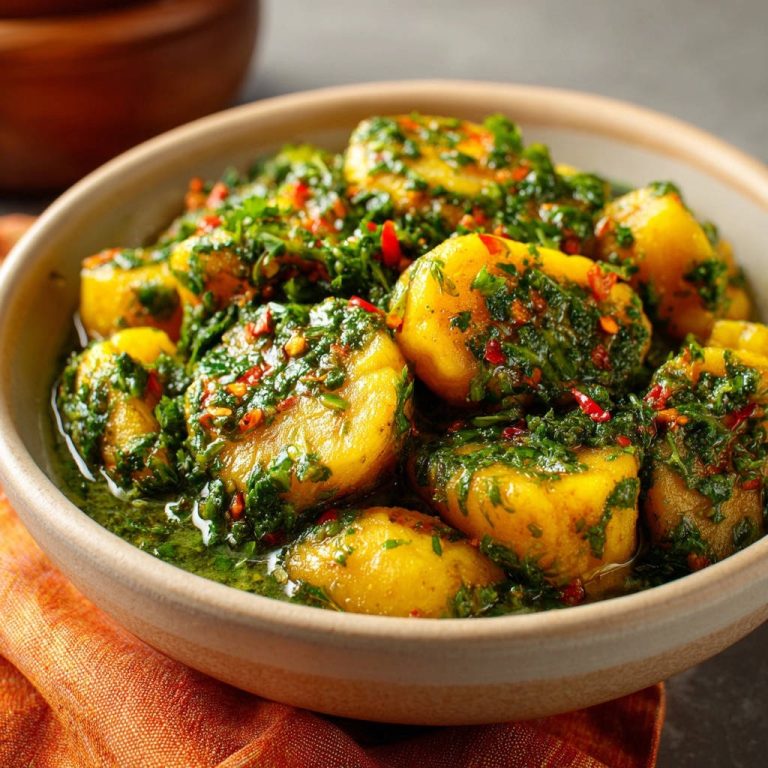 Garlicky herb potatoes served in a rustic bowl, showcasing a vibrant parsley and chili herb sauce.
