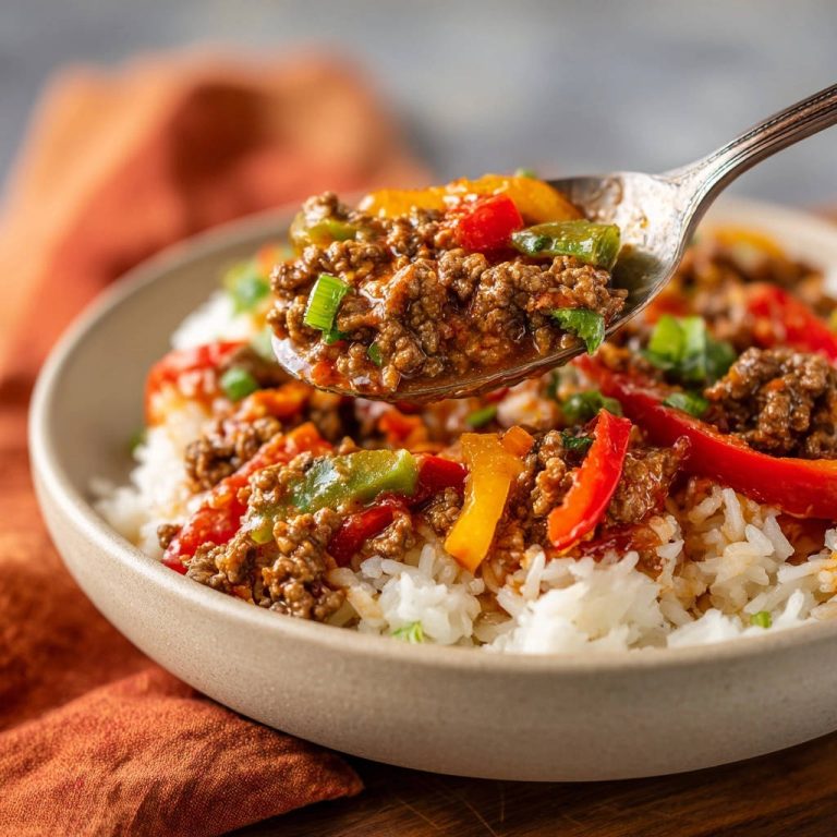 Easy weeknight ground beef and peppers served in a bowl with a spoon lifting a flavorful bite.