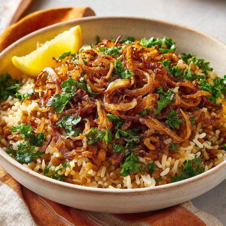 Mujadara with shatteringly crispy onions and fresh parsley, served with a lemon wedge.