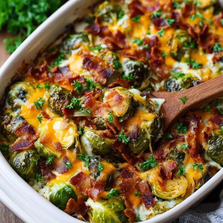 Cheesy bacon Brussels sprouts casserole with a wooden spoon scooping a serving, topped with melted cheese and bacon.