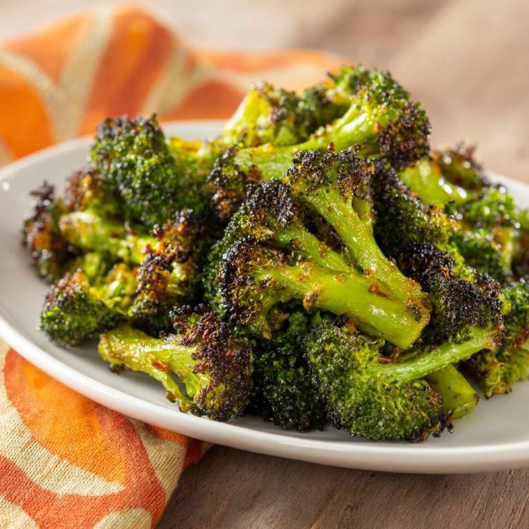 Crispy roasted broccoli showing a close-up view of its textured florets and charred edges.