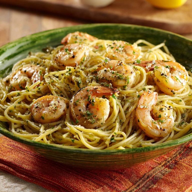 Lemon garlic shrimp pasta with tender, juicy shrimp served in a green bowl, close-up view.